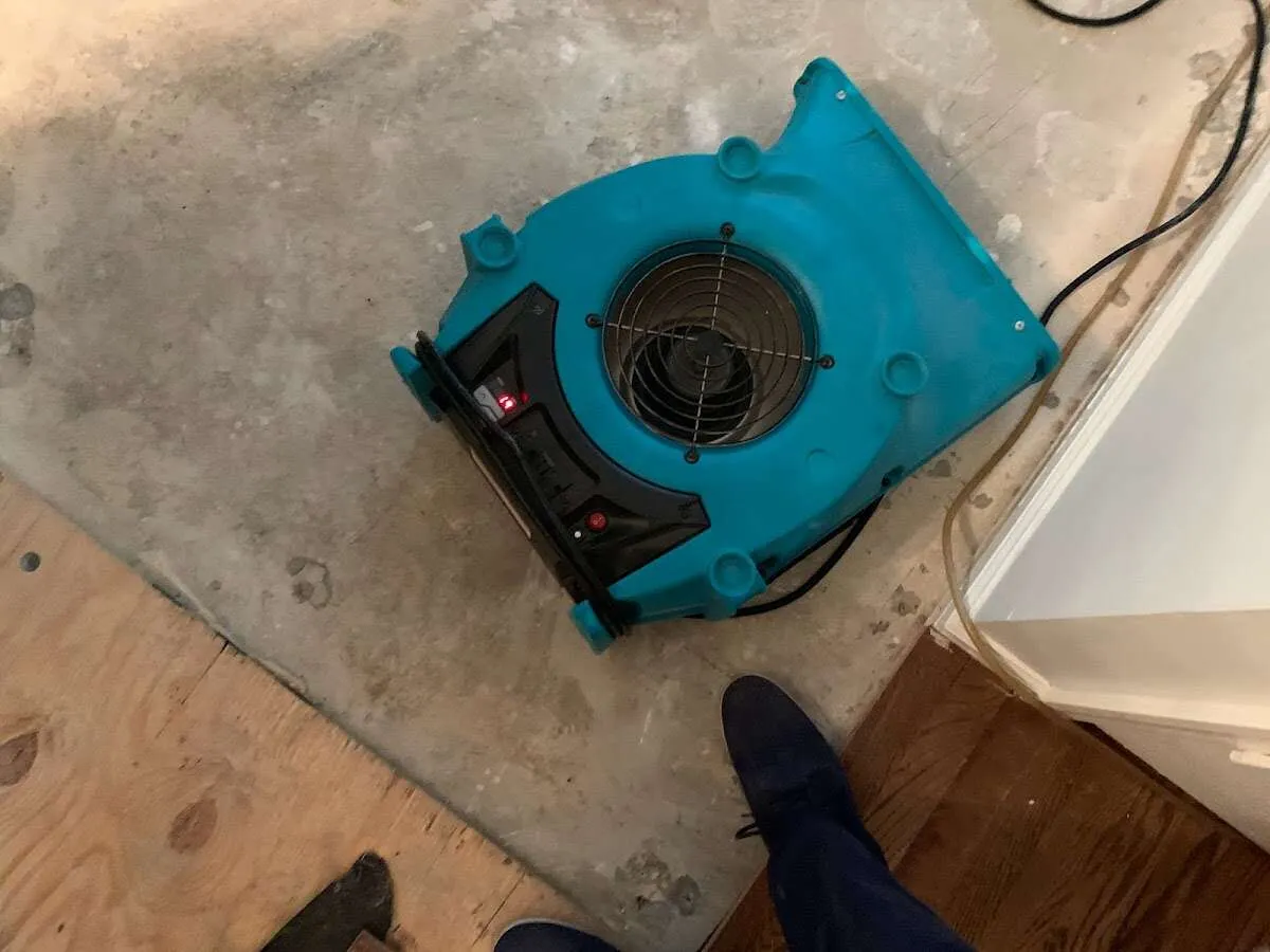 Air mover drying subfloor during Commercial Water Damage Restoration in Lutherville